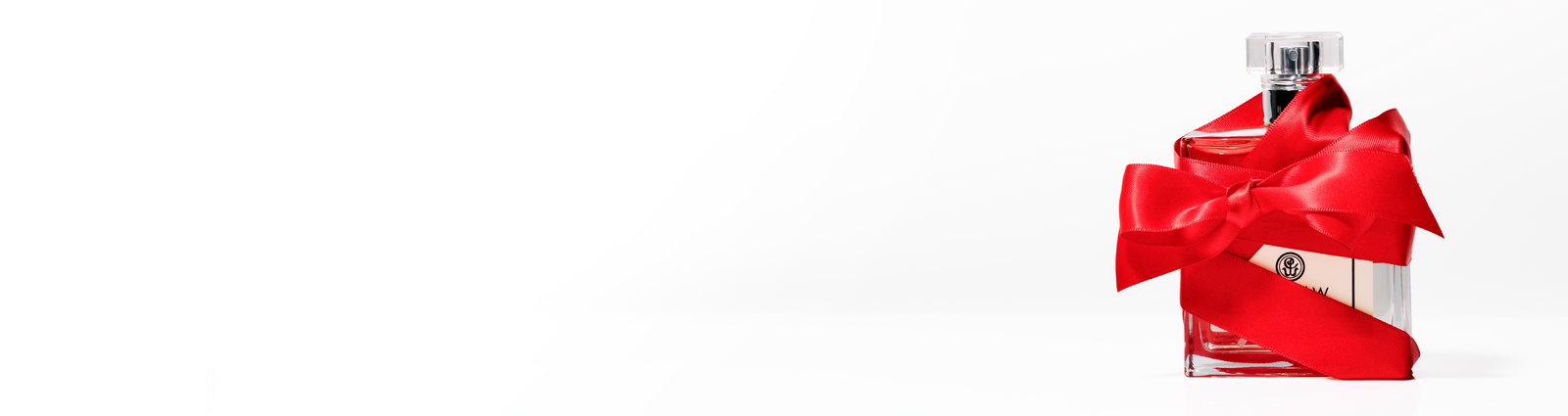 Close-up of a vibrant pink flower with delicate petals and a prominent yellow and brown center displaying a radial pattern. The petals have a soft, translucent texture and slightly ruffled edges.