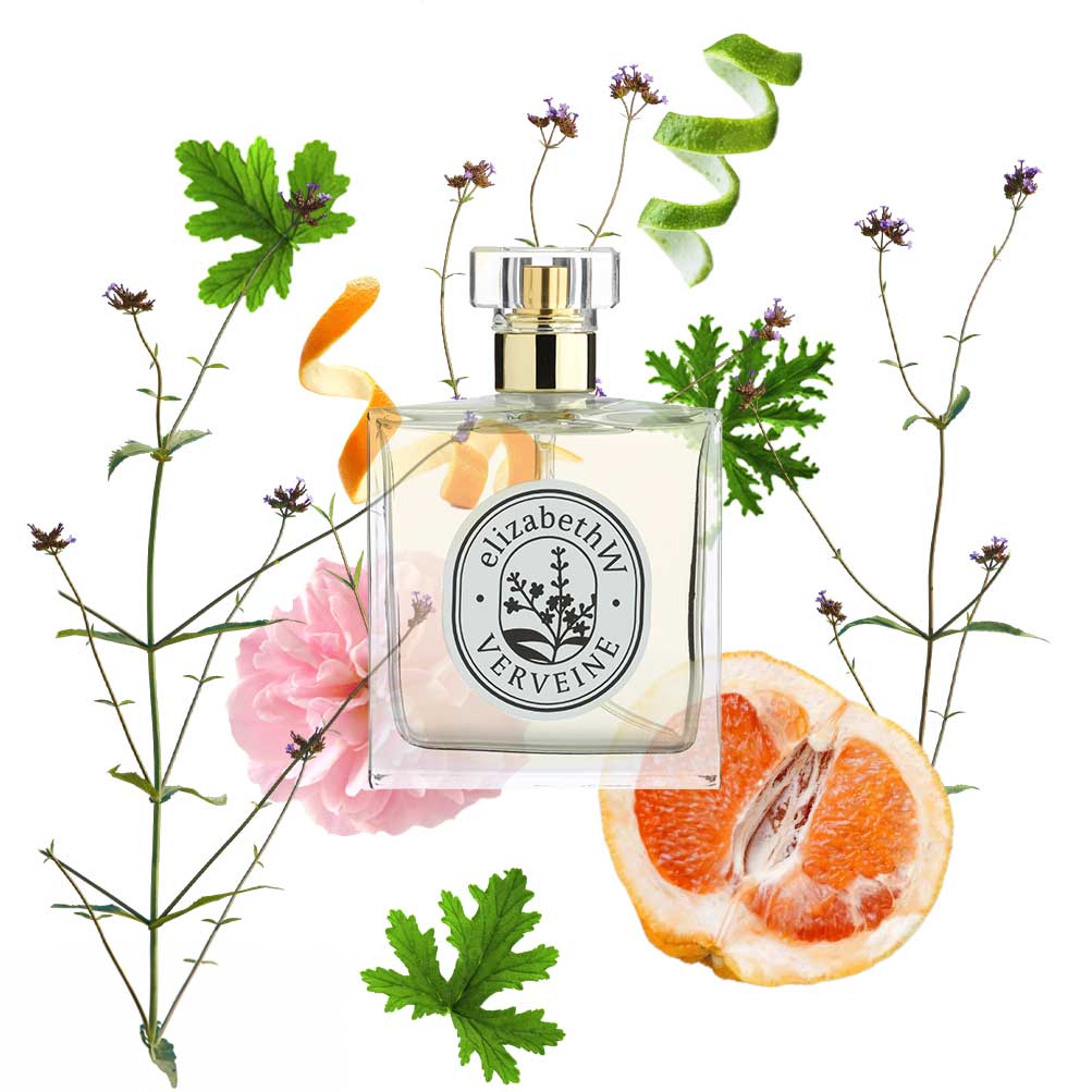 Three small ceramic vases holding vibrant pink flowers sit on a marble countertop near a window, with golden kitchen fixtures in the background. The scene is brightly lit by natural light.