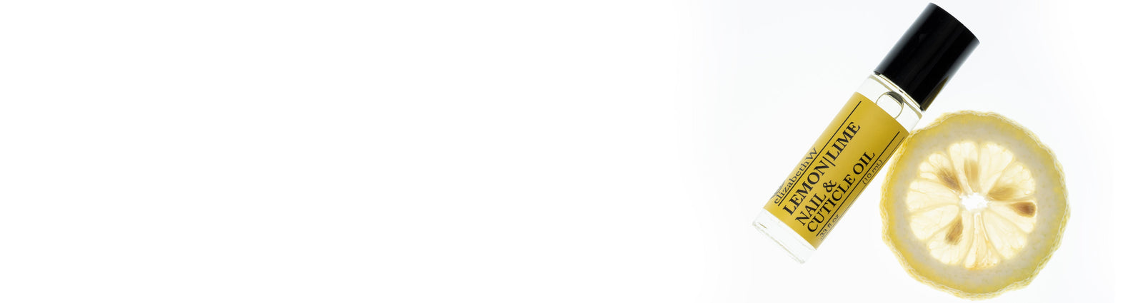 A collection of bath and body products including Magnolia soap, a bottle of Vetiver body oil, Vetiver eau de parfum, Lavender hand cream, and Magnolia body lotion, all from the brand elizabethW.