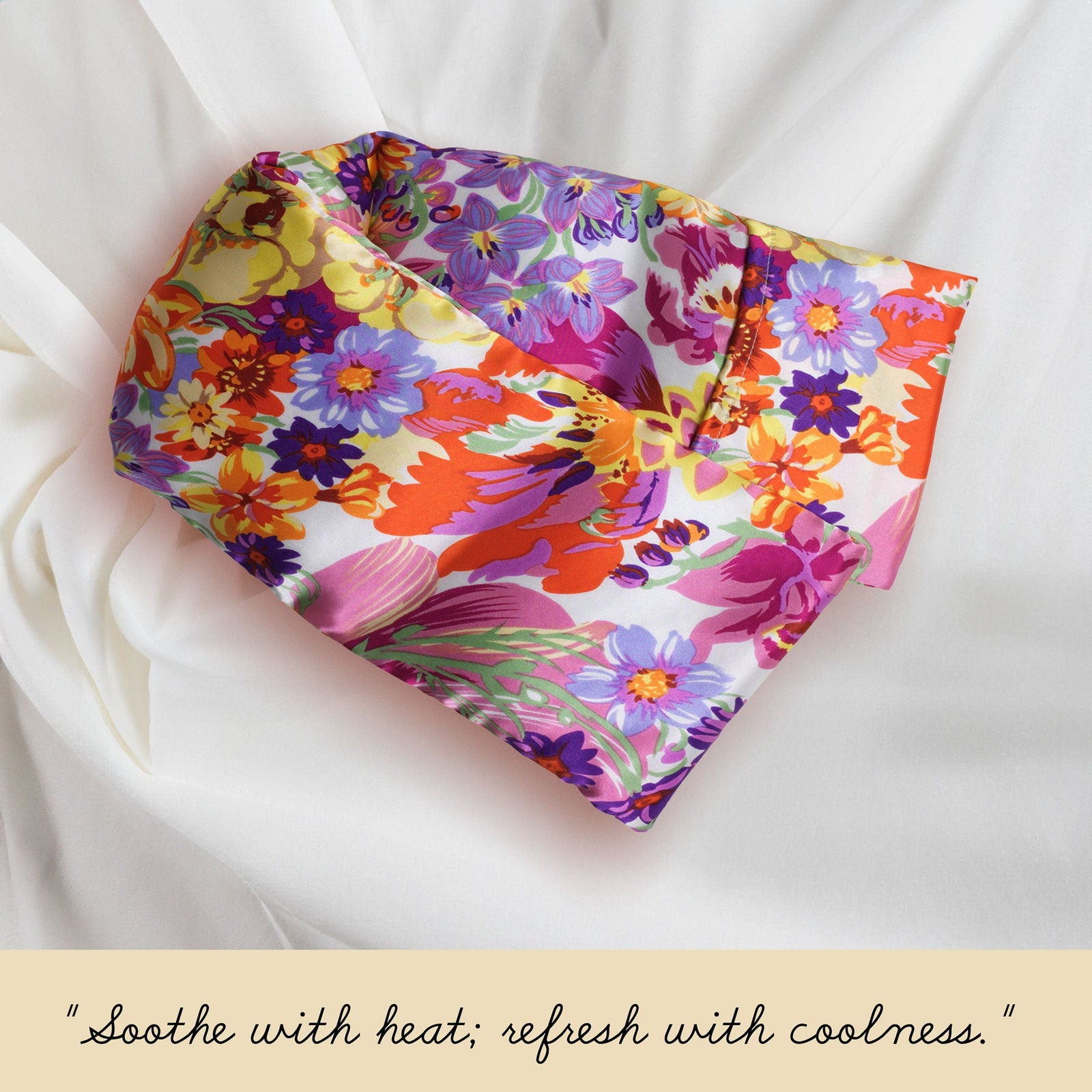 A colorful, floral-patterned cloth wrap against a peach background. The text below reads, "Soothe with heat; refresh with coolness.