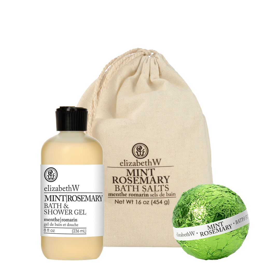 The Mint Rosemary Bath Bundle by elizabethW, featuring a bath & shower gel, mint rosemary bath salts in a bag, and a green foil-wrapped fizz ball—all displaying the elizabethW brand—are artfully displayed against a white background.