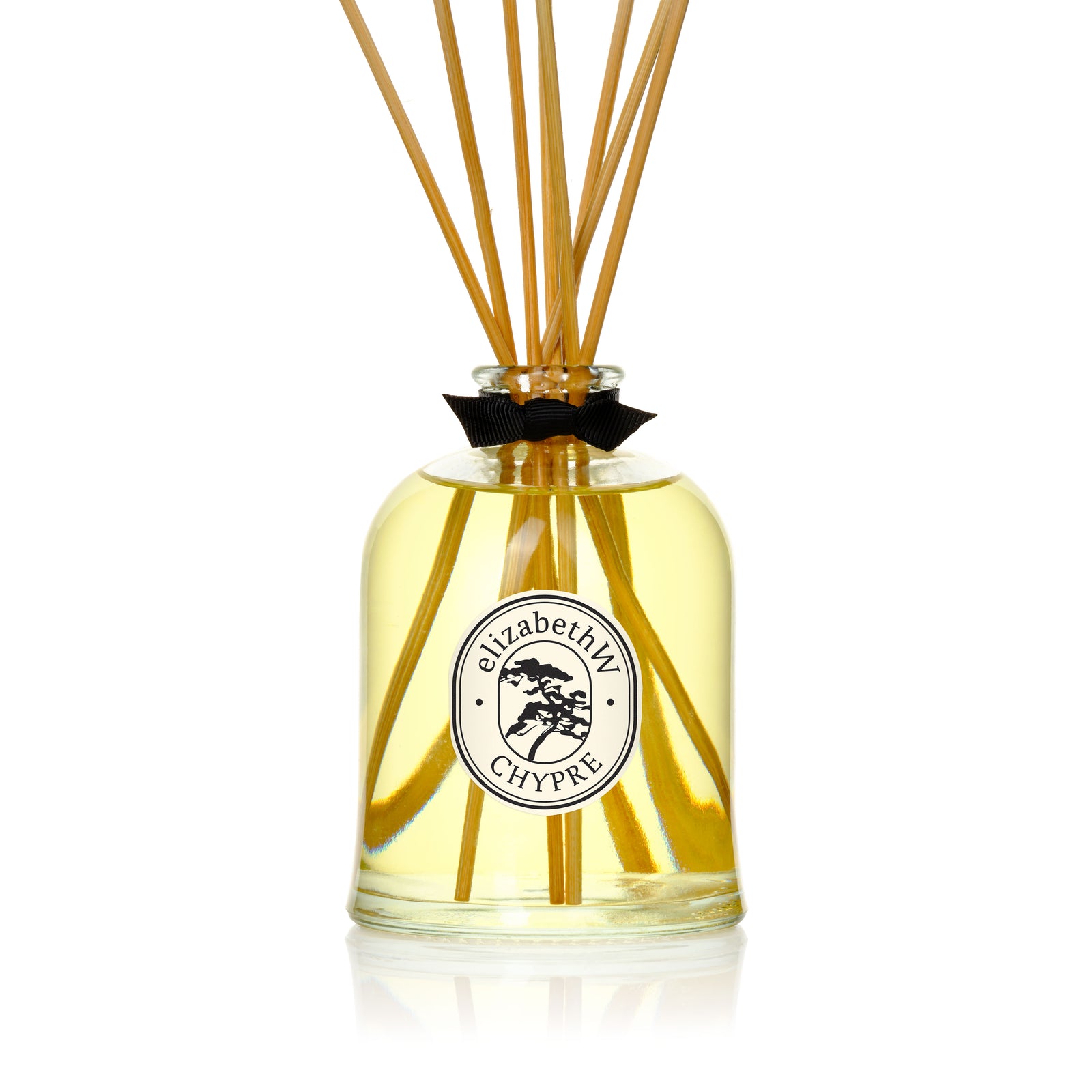 The elizabethW Chypre — Diffuser features a glass bottle with yellow liquid, natural reed sticks, and a black ribbon, all set against a white background—an eco-friendly choice for long-lasting fragrance.