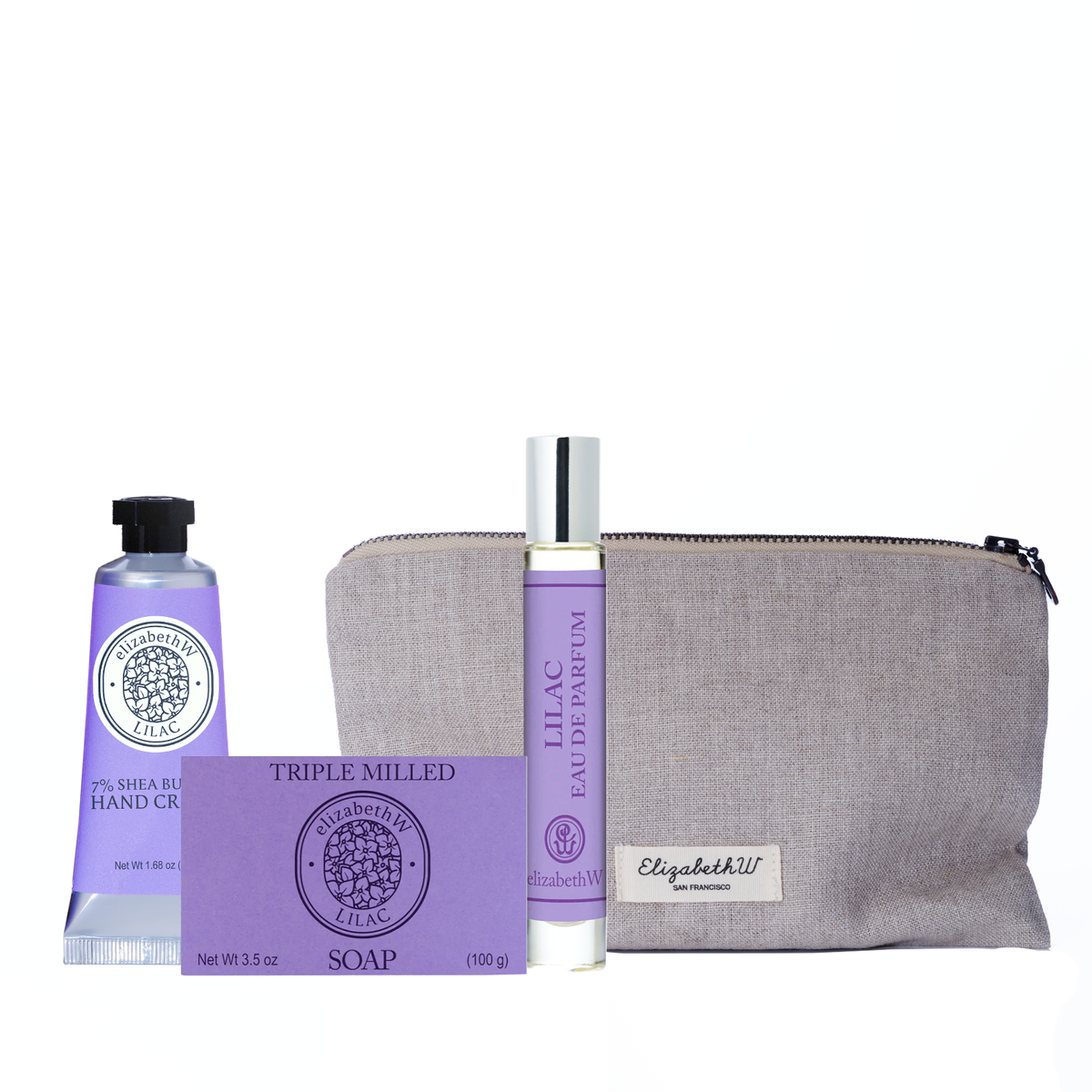 The Lilac Self-Care Bundle by elizabethW features a triple milled soap, shea butter hand cream, and lilac eau de parfum with purple accents, arranged before a light beige pouch labeled "elizabethW.