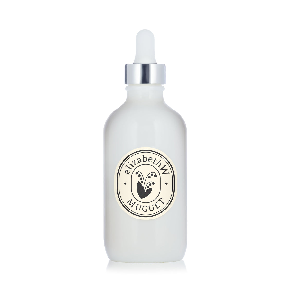 A sleek white dropper bottle with a silver cap and an "elizabethW Muguet" label is shown against a white background. Inside, the Muguet — Body Oil by elizabethW offers nourishing hydration for your skin, infused with the soft, floral scent of Muguet for a luxurious moisturizing experience.