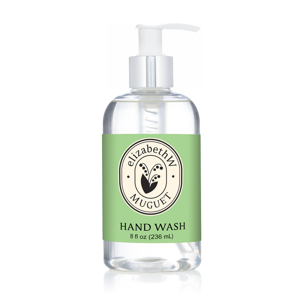 ElizabethW Muguet — Hand Wash, 8 fl oz (236 mL), comes in a clear pump bottle with a light green floral label and circular logo, offering a botanical wash inspired by the fresh lily of the valley scent.