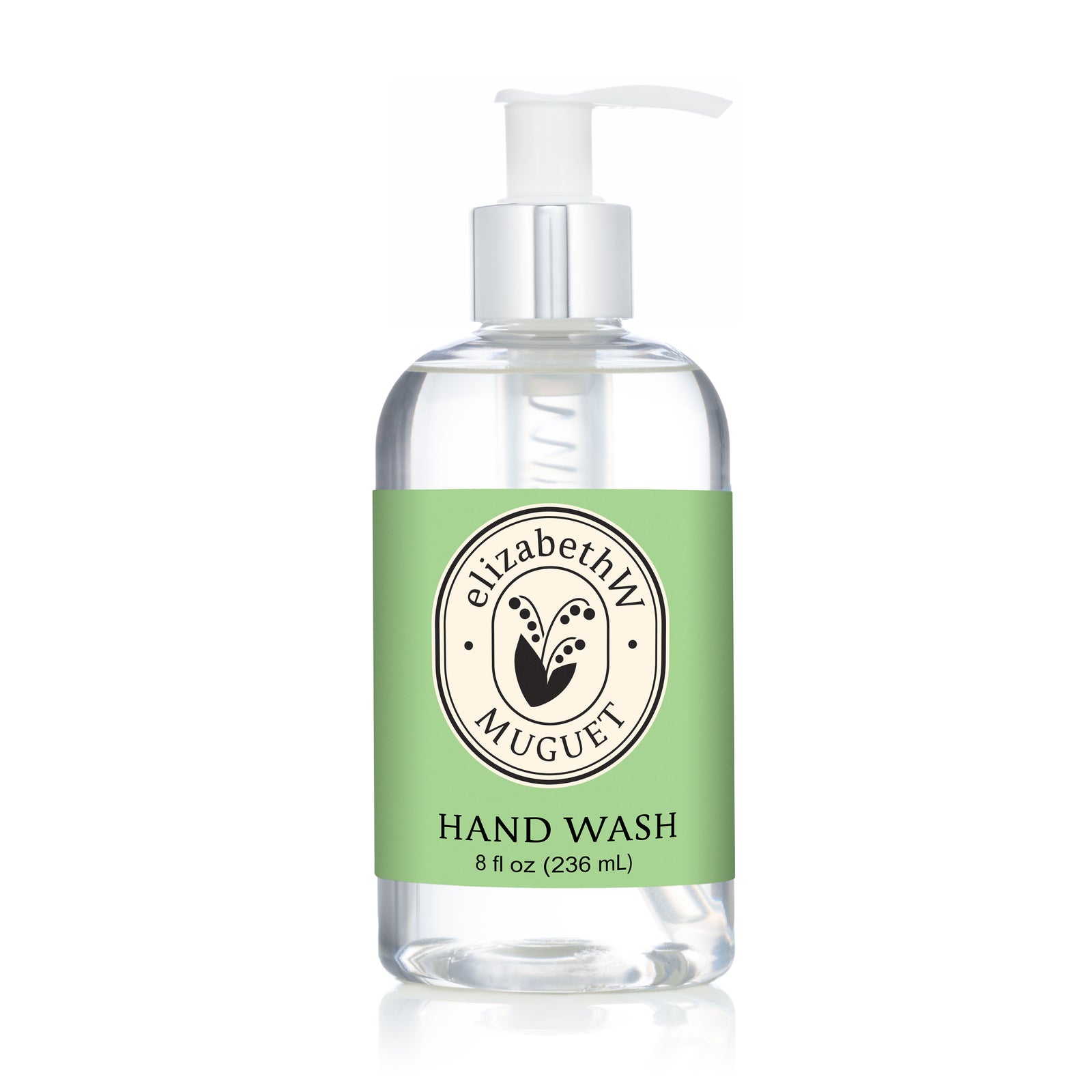 ElizabethW Muguet — Hand Wash, 8 fl oz (236 mL), comes in a clear pump bottle with a light green floral label and circular logo, offering a botanical wash inspired by the fresh lily of the valley scent.
