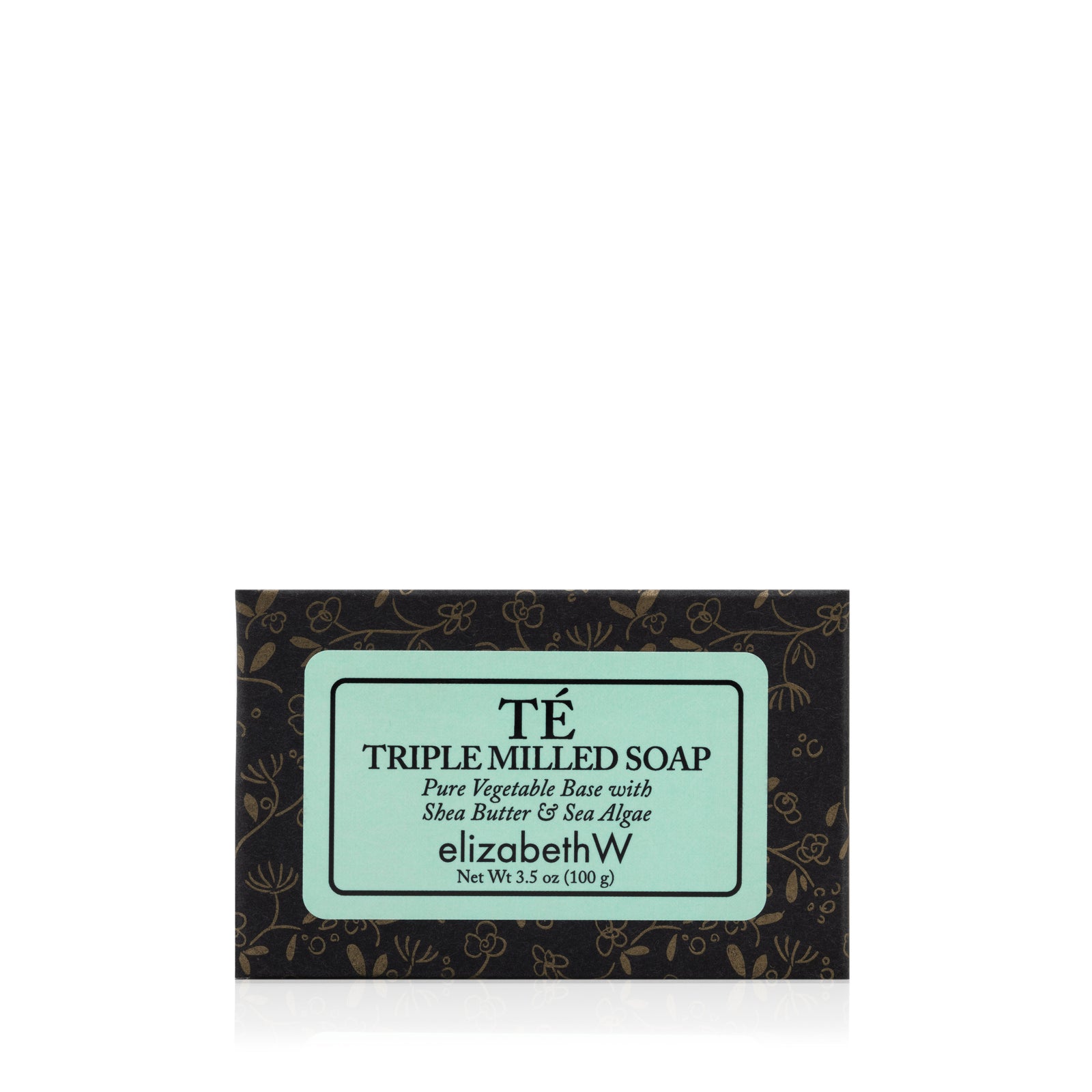 A bar of elizabethW Té — Triple Milled Soap, a luxurious plant-based soap infused with the subtle aroma of oriental black tea, elegantly packaged in a decorative black and gold box featuring a light blue label with detailed ingredients and product information.