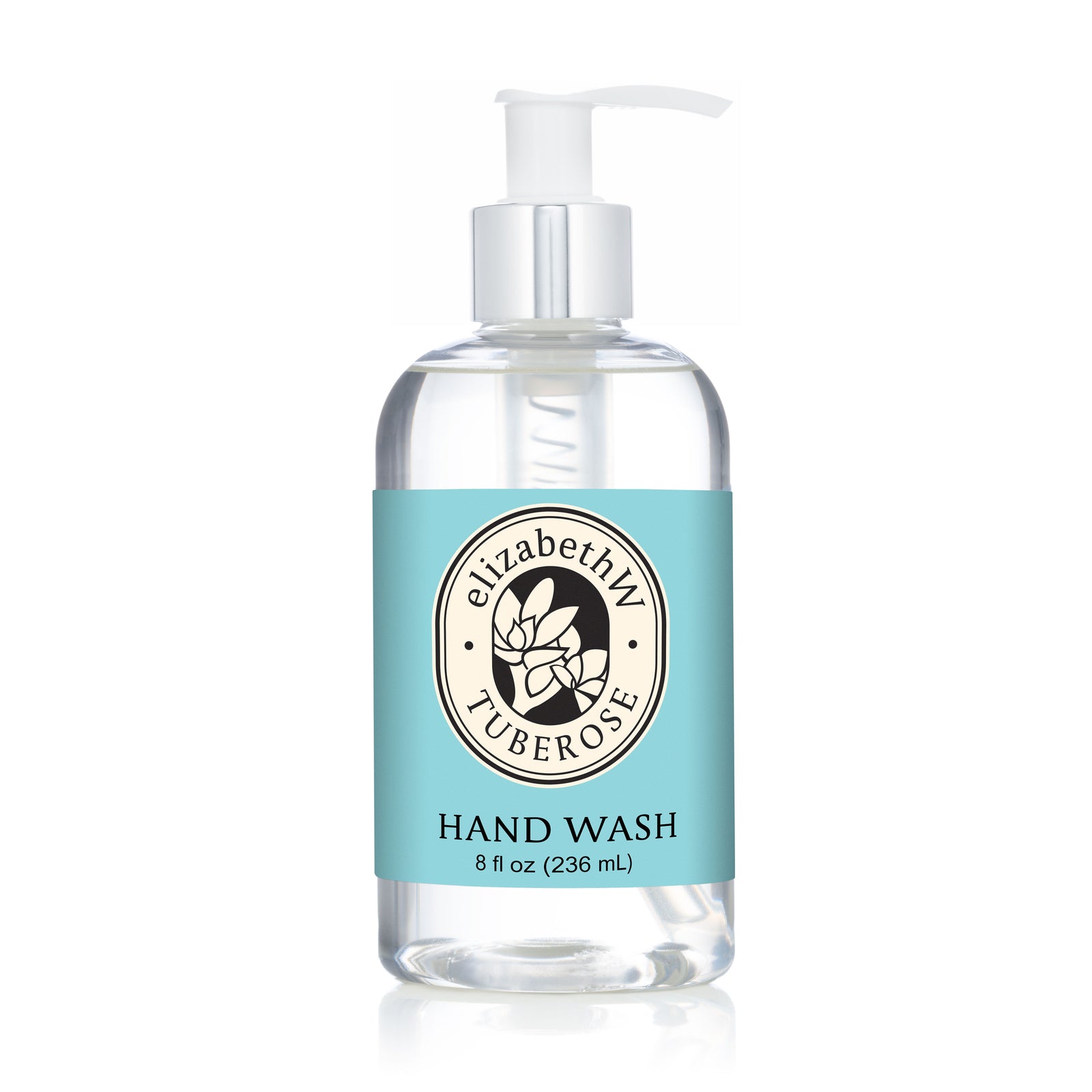 A clear pump bottle of E Wightman & Co Tuberose — Hand Wash features a light blue label, a leaf logo on the front, and transparent moisturizing hand wash inside.