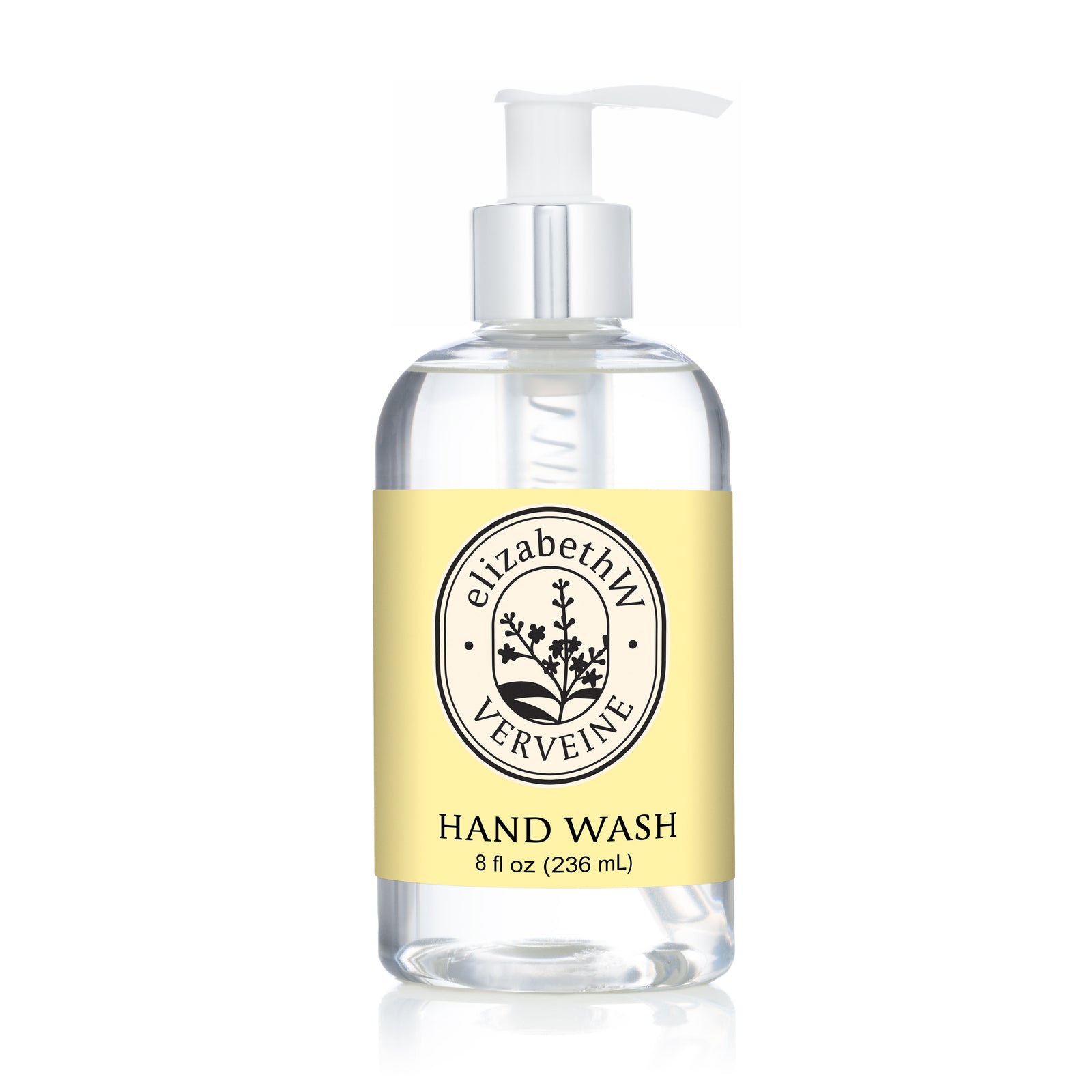 A clear pump bottle labeled "elizabethW Verveine — Hand Wash" features a light yellow label and black botanical logo, perfectly complementing this refreshing botanical cleanser.