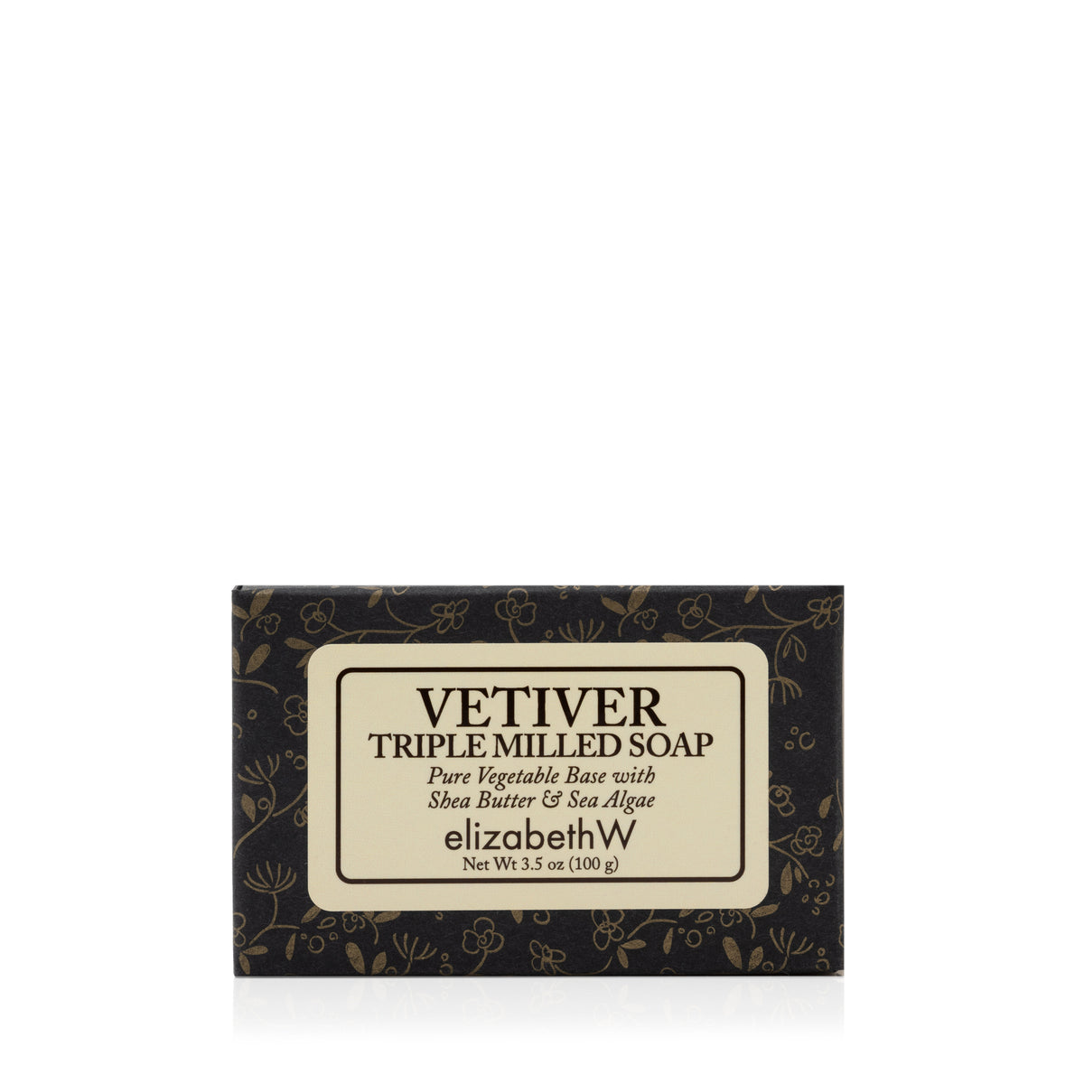 A 3.5 oz (100g) bar of elizabethW’s Vetiver — Triple Milled Soap, presented in black floral packaging, is crafted from a pure vegetable base with shea butter and sea algae, and made using plant-based ingredients.