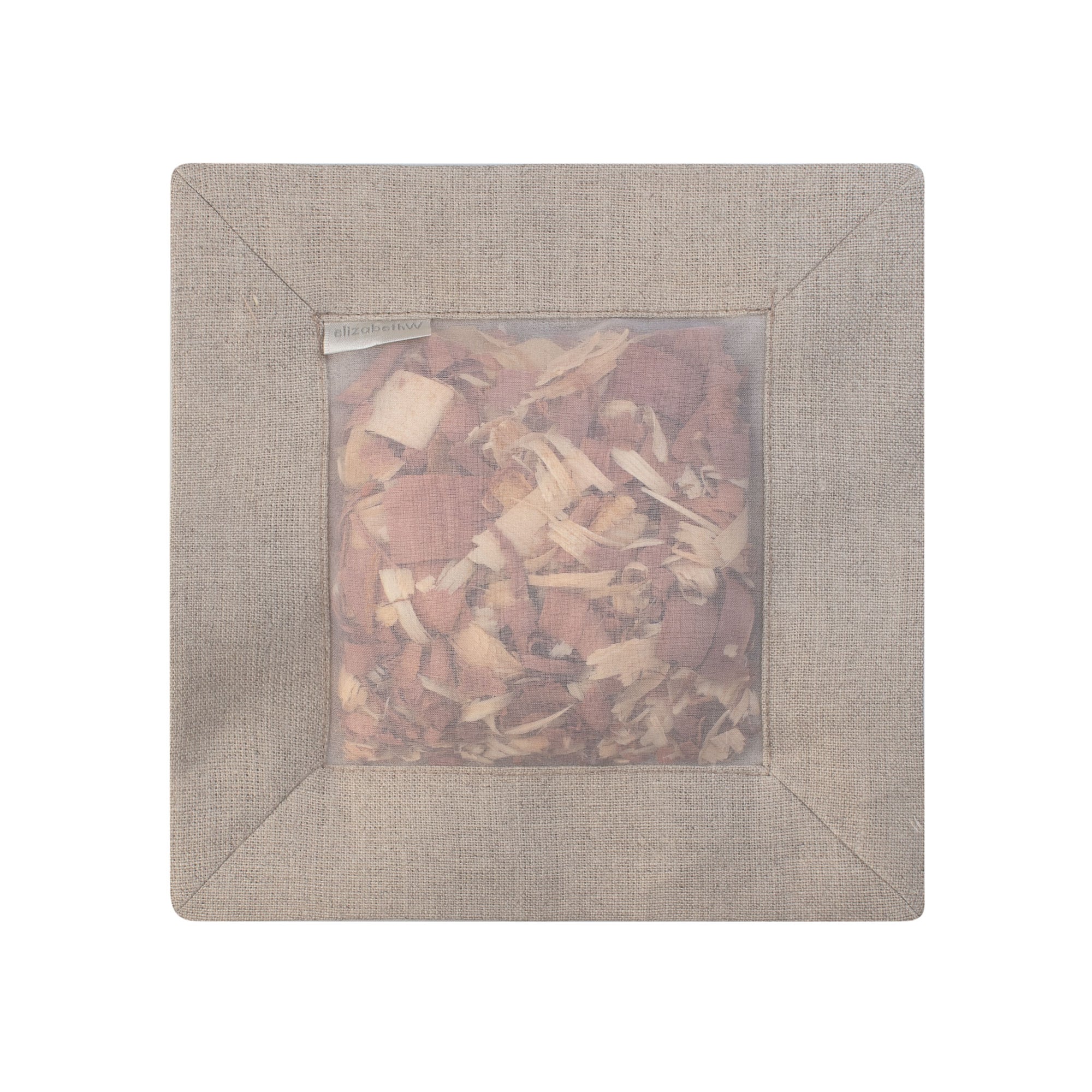 Cedar filled inside of a "natural" colored square sachet with a transparent screen