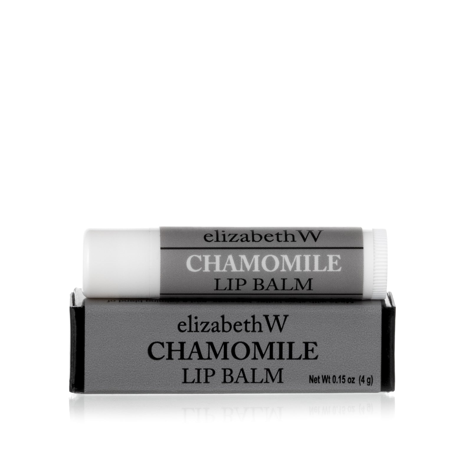 A tube of Chamomile Lip Balm placed on top of its matching gray and black box. The tube and box are both labeled with the product name in black text on a gray background.