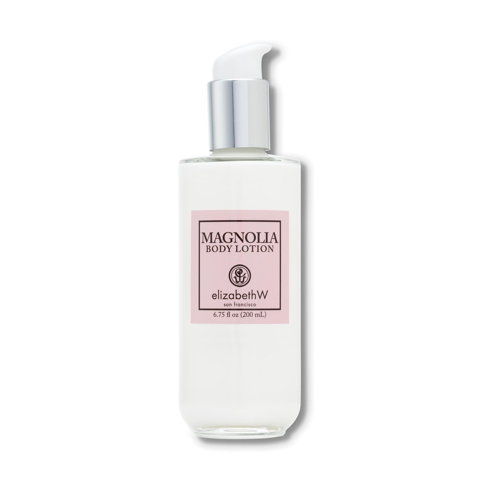 A 6.75 fl oz (200 mL) clear glass bottle of body lotion with a silver pump dispenser. The label reads "Magnolia Body Lotion," with the elizabethW logo and "san francisco" below. The light pink label and minimalist design reflect a clean and elegant aesthetic.