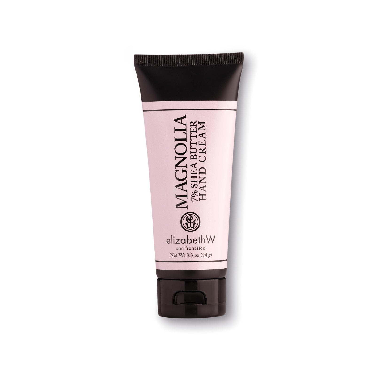 A 3.3 oz (94 g) light pink-colored tube of Magnolia hand cream with a black cap and black text. The label reads "Magnolia 7% Shea Butter Hand Cream," with the elizabethW logo and "san francisco" beneath it. The net weight of the product is also listed on the label.