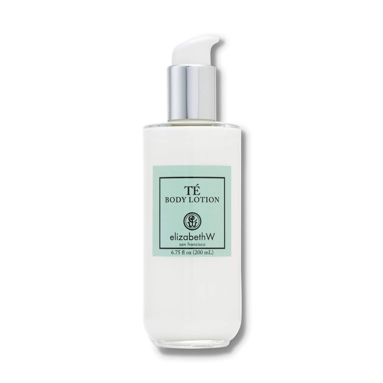A 6.75 fl oz (200 mL) clear glass bottle of body lotion with a silver pump dispenser. The label reads "TE Body Lotion," with the elizabethW logo and "san francisco" below. The teal label and minimalist design reflect a clean and elegant aesthetic.