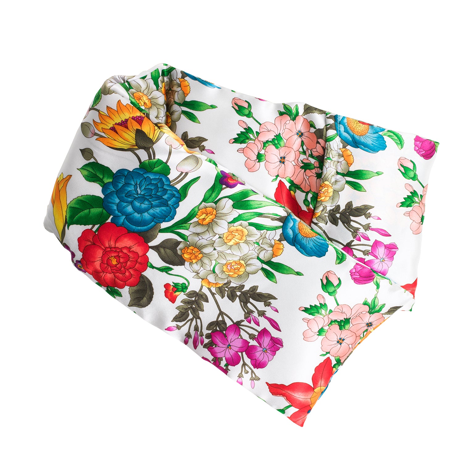 Neatly arranged against a plain white background, the elizabethW Floral Blush Hot/Cold Flaxseed Pack is covered in a silk casing, with various flowers in shades of red, blue, yellow, pink, and green. Can be used as a heat pad or cold compress.