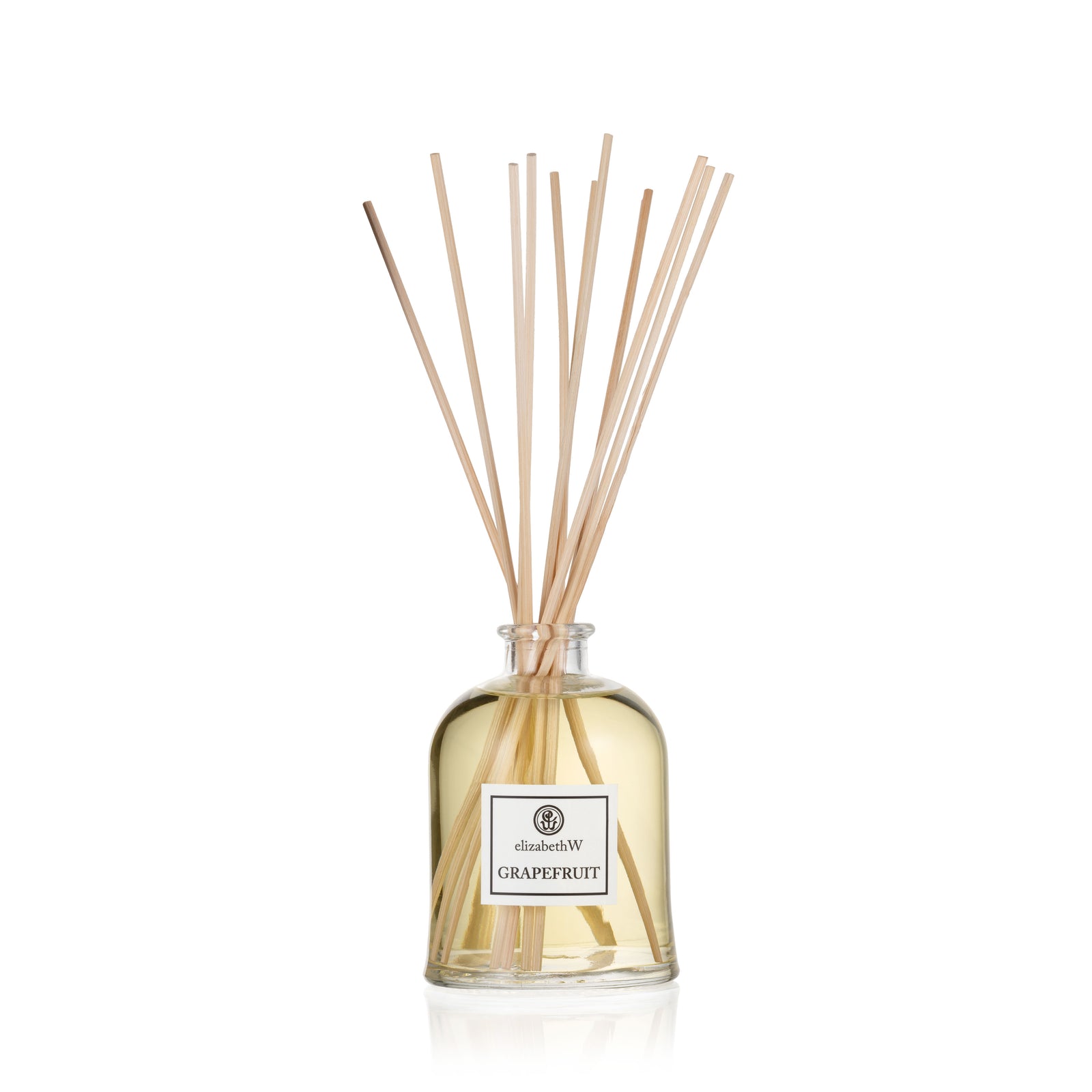 Grapefruit Room Diffuser by elizabethW. A clear glass bottle filled with fragrance oil and long diffuser reeds extending from the top.