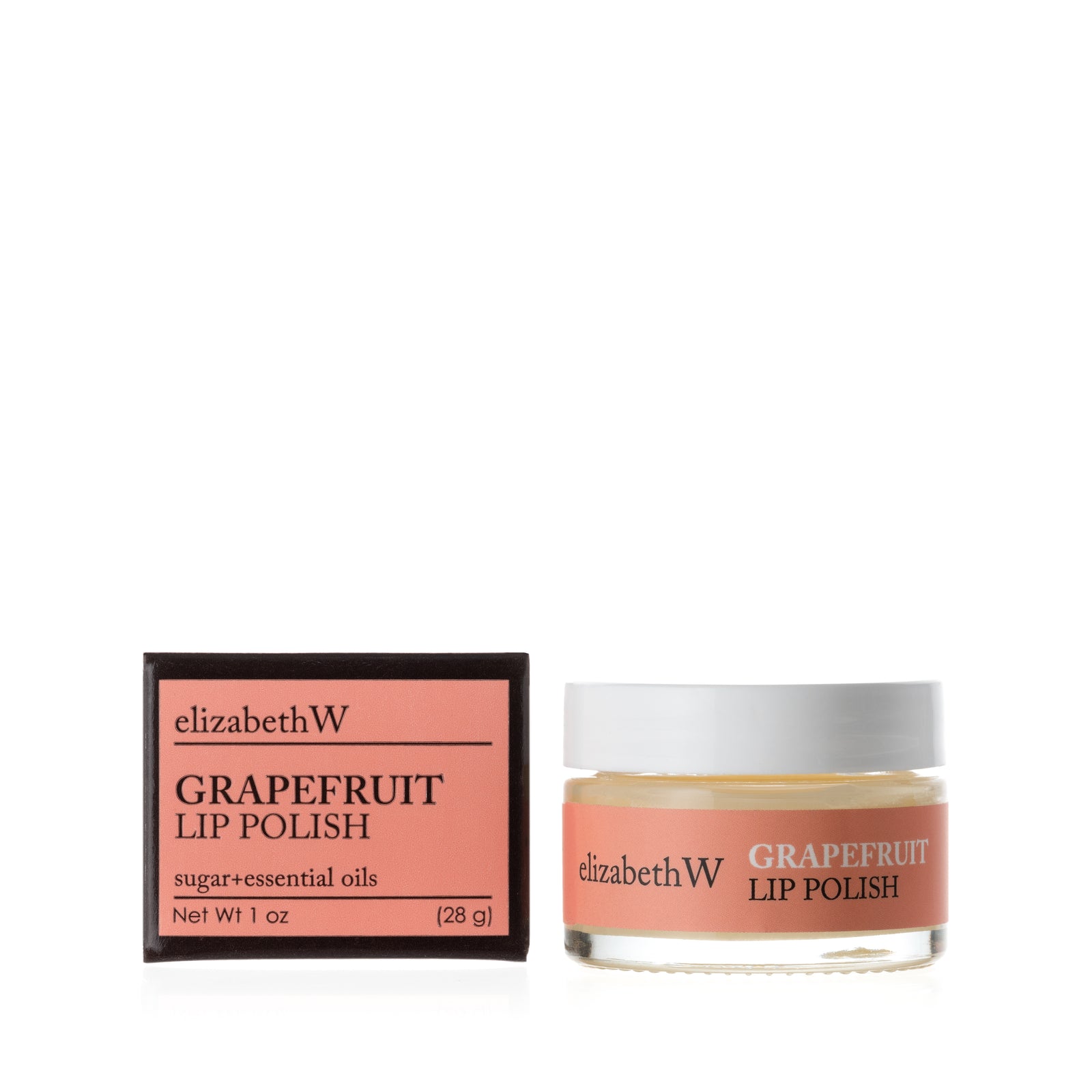 A glass jar of Grapefruit Lip Polish beside its matching black and light orange box. The jar contains a smooth white lip polish with a light orange label.
