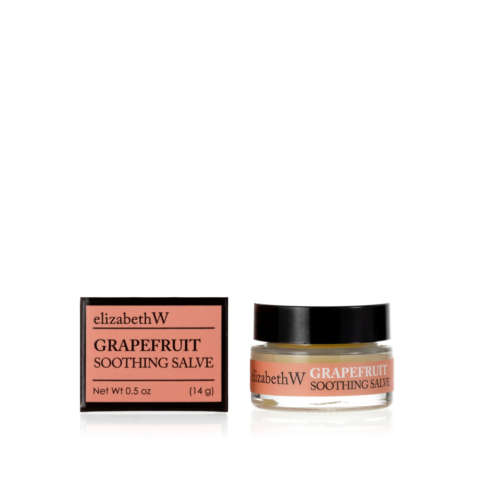 .5 oz (14g) glass jar of Grapefruit Soothing Salve with a matching light orange and black box. The jar contains salve, and the box displays the product name and the brand elizabethW in black text on a light orange background.
