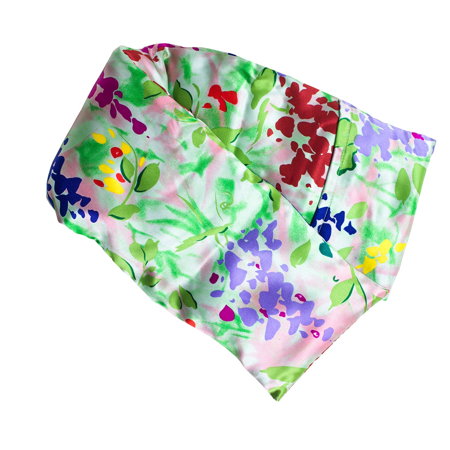 Neatly arranged against a plain white background, the elizabethW Impressions Hot/Cold Flaxseed Pack features a vibrant, floral print adorned with green leaves and flowers, covered in a silk casing, and can be used as a heat pad or cold compress.