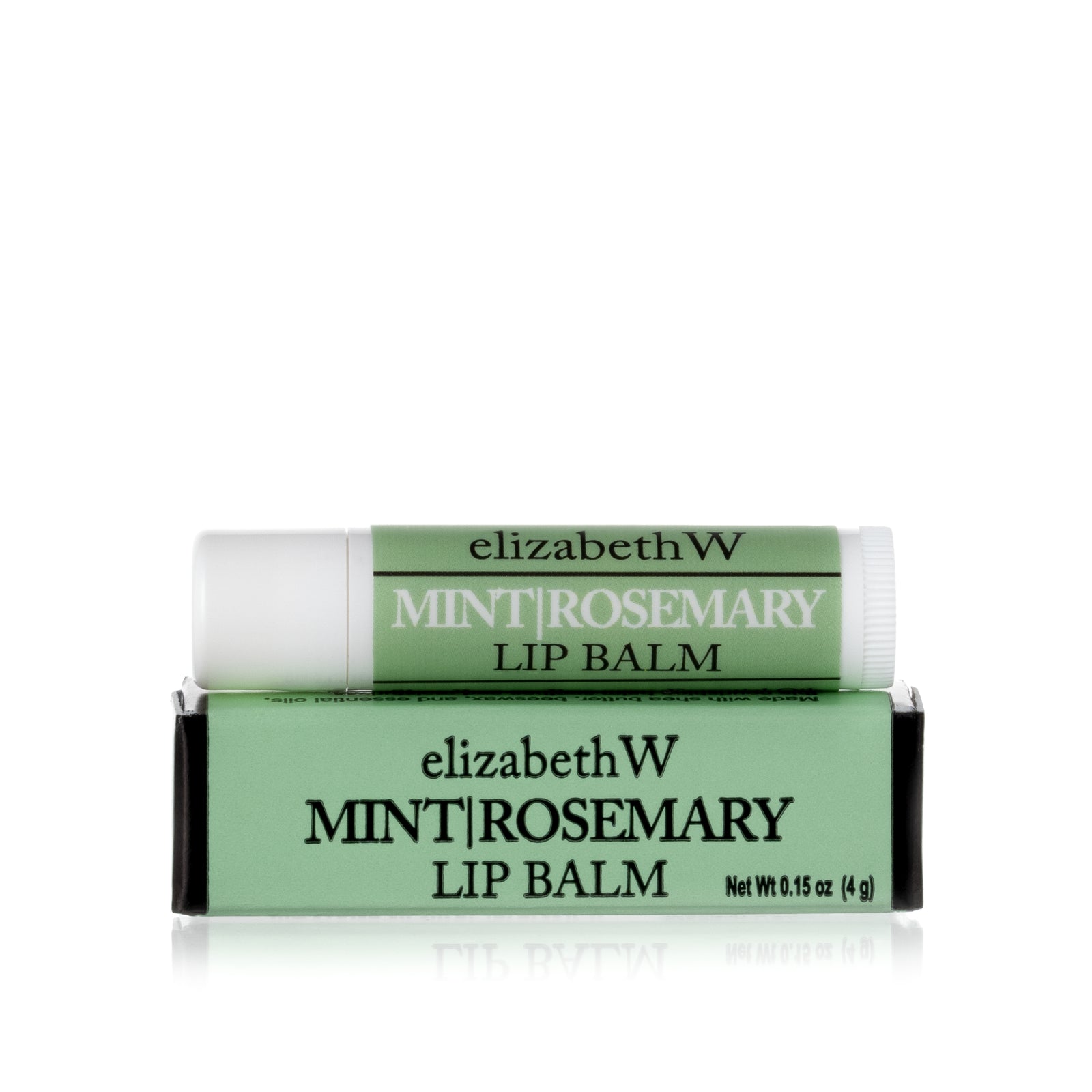 A tube of Mint|Rosemary Lip Balm placed on top of its matching light green and black box. The tube and box are both labeled with the product name in black text on a light green background.