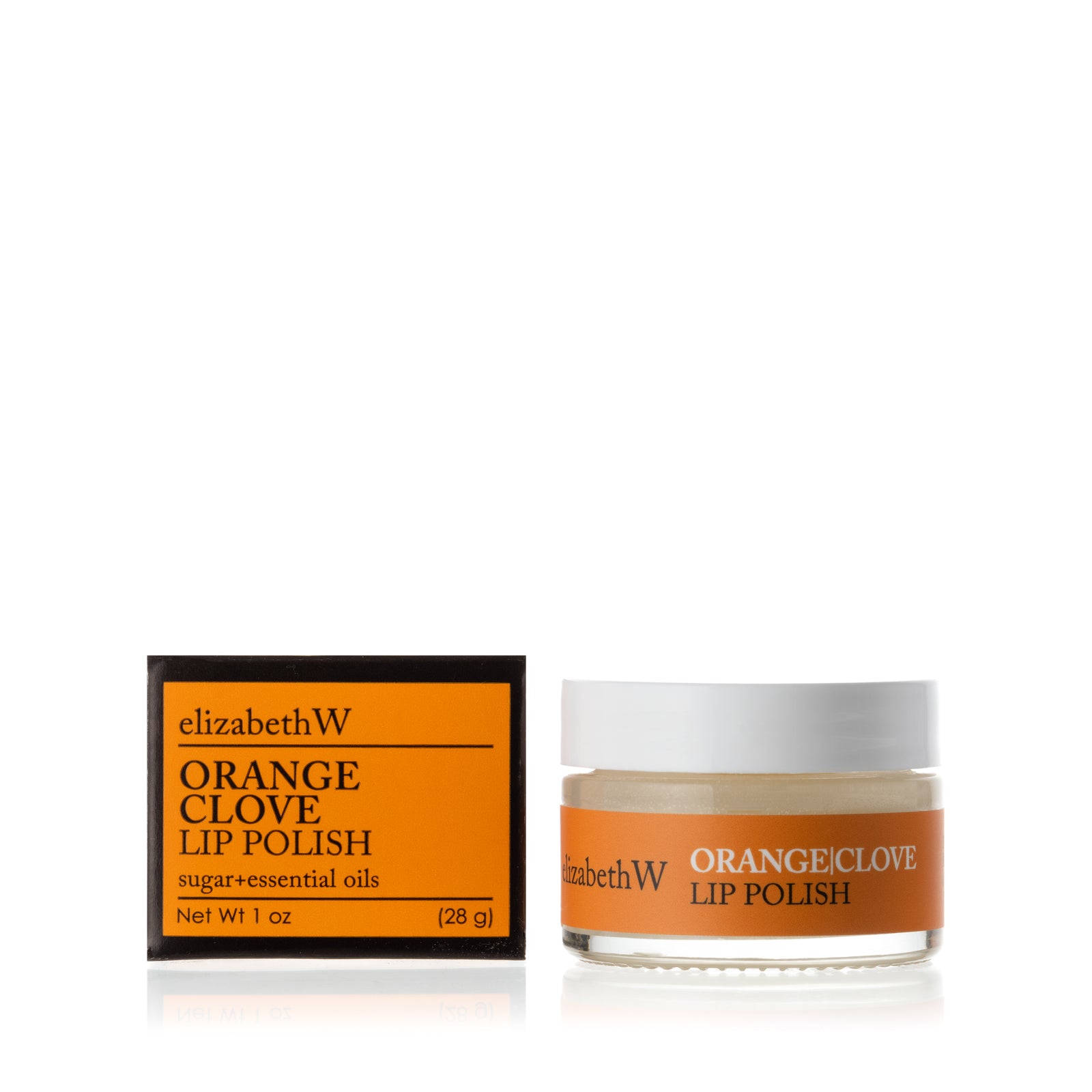 A glass jar of Orange Clove Lip Polish beside its matching black and orange box. The jar contains a smooth white lip polish with a orange label.