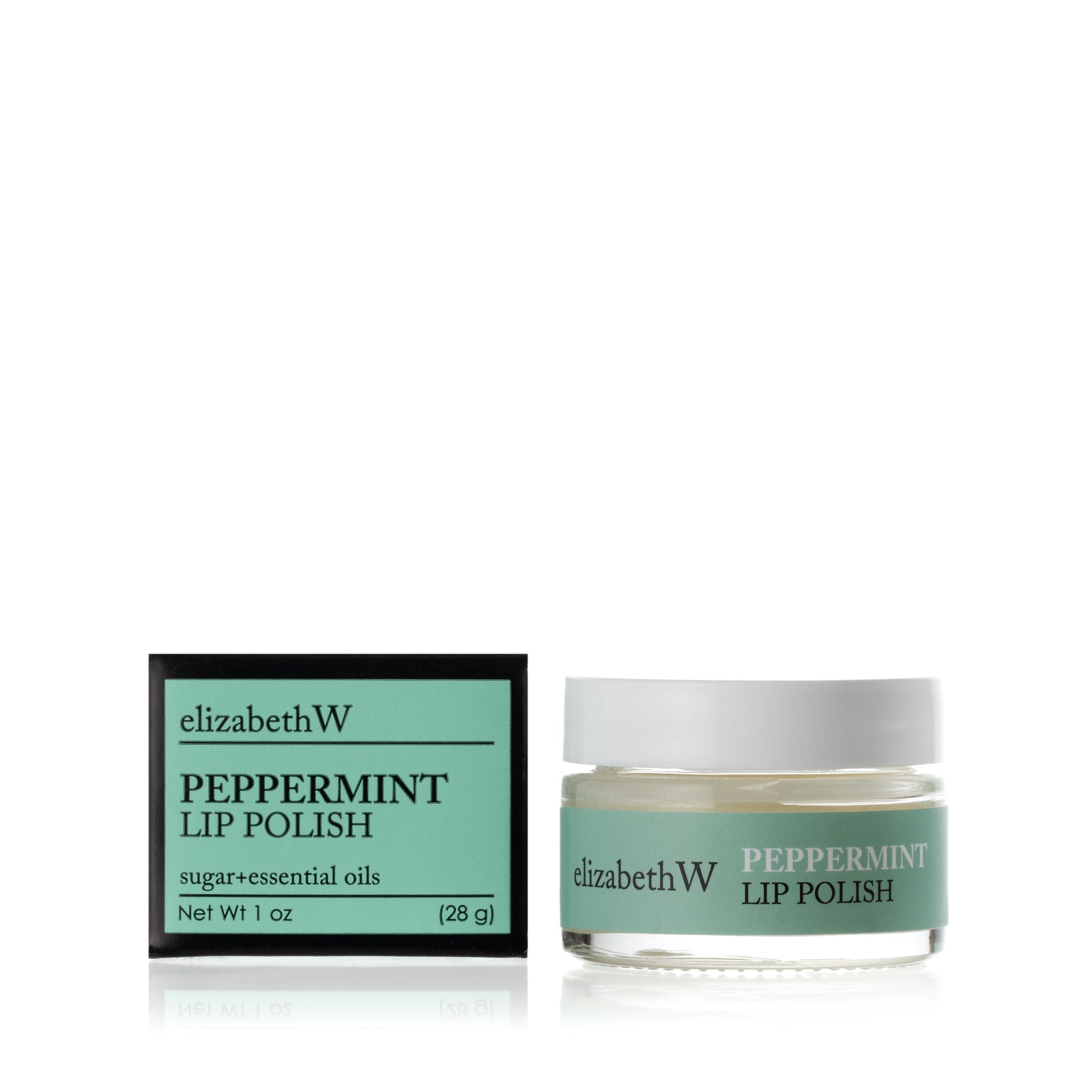 A glass jar of Peppermint Lip Polish beside its matching black and light green box. The jar contains a smooth white lip polish with a light green label.