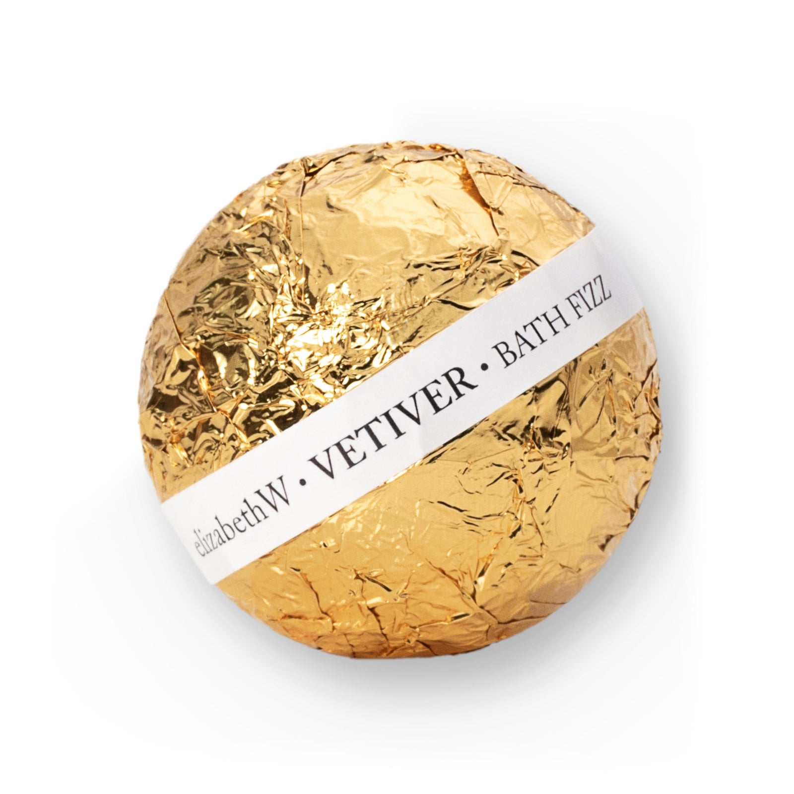 A gold-wrapped, spherical bath fizz ball. A white label band wraps around the center, reading "elizabethW Vetiver Bath Fizz."